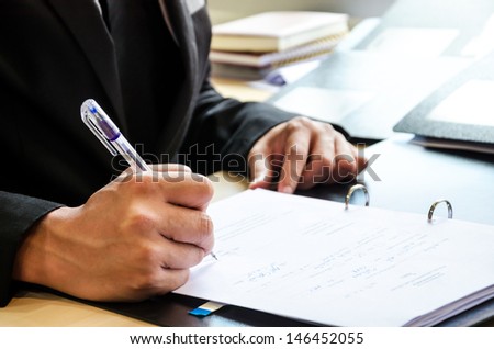 Business people who work hard and are signing the document.