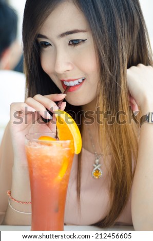Portrait of happy smiling young beautiful woman with lemon tea, in restaurant