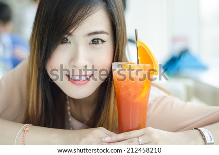 Portrait of happy smiling young beautiful woman with lemon tea, in restaurant