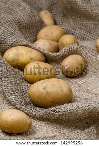 Raw potatoes on the old rag bag
