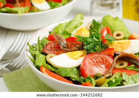 Salad Nicoise with tomatoes, green beans, tuna, eggs and anchovies dressed with vinaigrette
