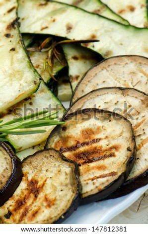 Grilled aubergine with pumpkins, close up