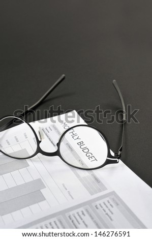 Balance sheet and eye glasses on the table