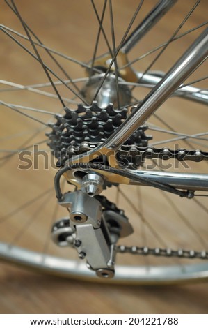 Bicycle\'s detail view of rear wheel with chain & sprocket