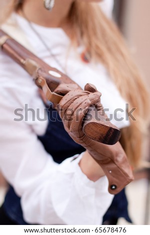 A women handing an old pistol