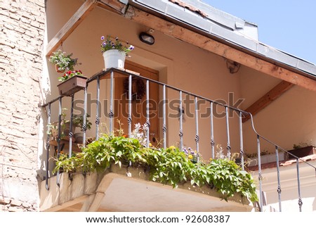 Old house with balcony with green plants in Vilnuis