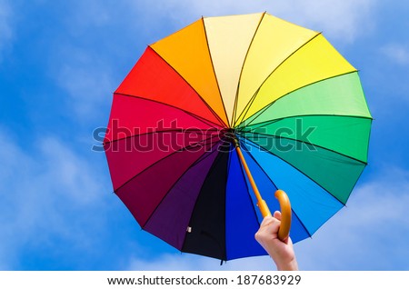 Rainbow umbrella\'s background against a blue sky