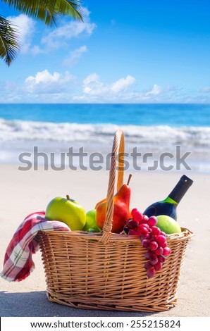 Picnic background with basket and fruits by the ocean