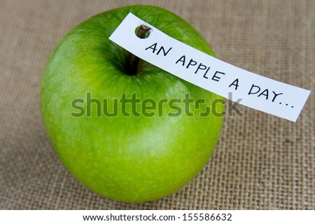 An apple a day sweet fresh green granny smith apple on burlap background