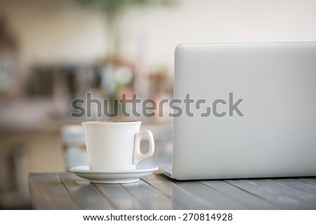 Laptop computer and coffee cup