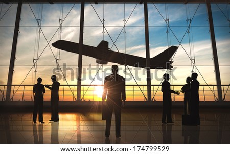 Business Man Standing And Business Group Silhouette In The Airport