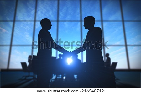 Two business shake hand in office silhouettes