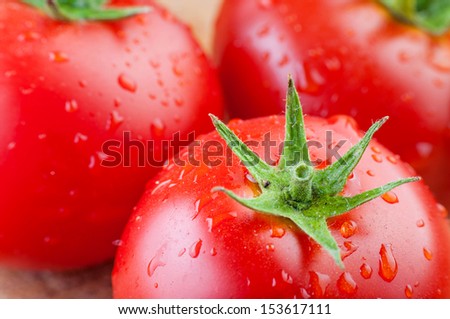 Two fresh tomatoes with water drops and shallow depth of field