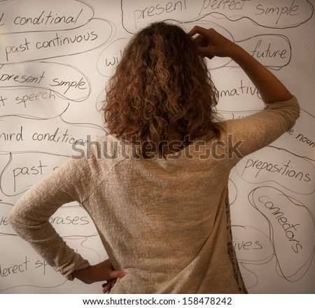 Student Puzzling Over English Grammar On A Whiteboard