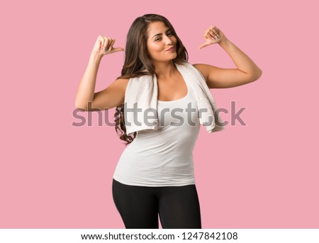 Full body young fitness curvy woman pointing fingers, example to follow