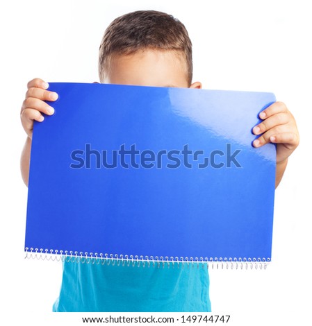 child hiding the face with a notebook on white background