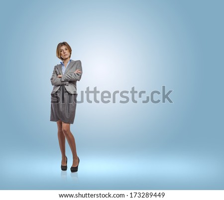 young business woman standing in a blue room