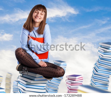 young woman hugging a book sitting on a books pile