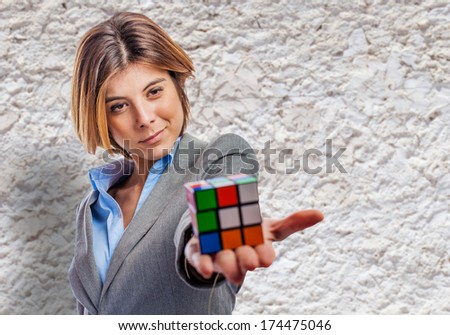 young business woman holding a rubik cube at street
