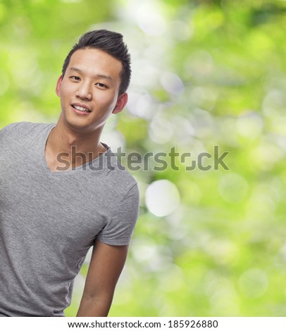 handsome young asian man smiling at park