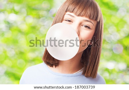girl doing a bubble with a chewing gum on a white background