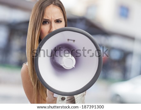 beautiful young woman shouting with a megaphone