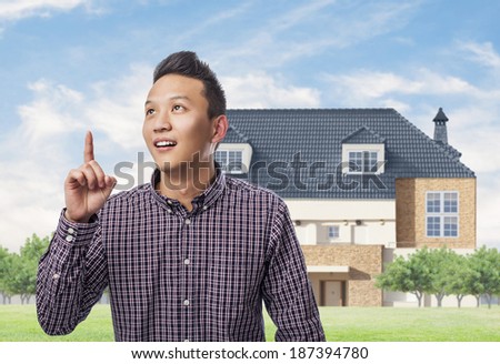 portrait of young asian man pointing up with finger