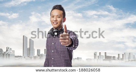 portrait of young asian man smiling with headphones
