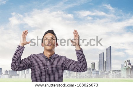 portrait of young asian man asking to the sky