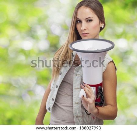 beautiful and serous young woman holding a megaphone