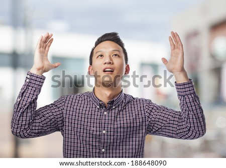 portrait of young asian man asking to the sky
