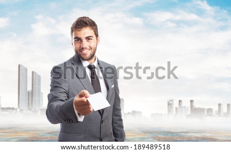 portrait of handsome business man offering his visit card