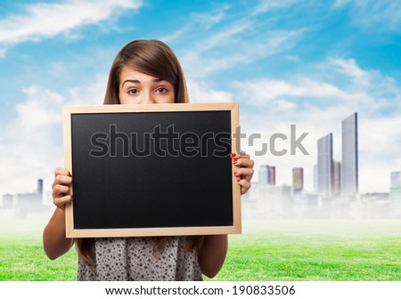 portrait of student hidden behind a chalkboard