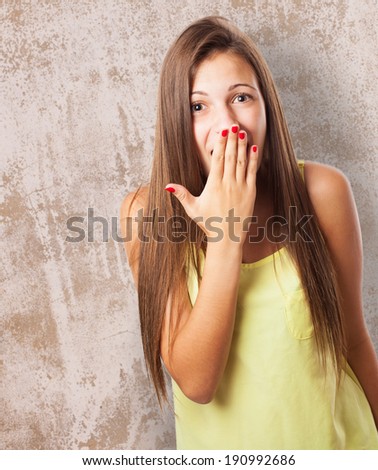 portrait of pretty young woman with her hand covering her mouth