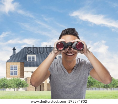handsome young asian man looking through a binoculars