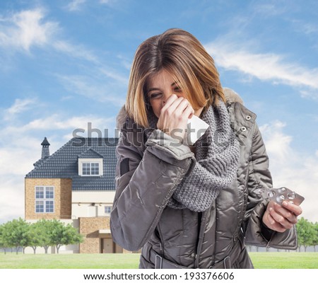 beautiful young woman sneezing and holding medicines