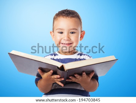 portrait of a cute kid holding a big book