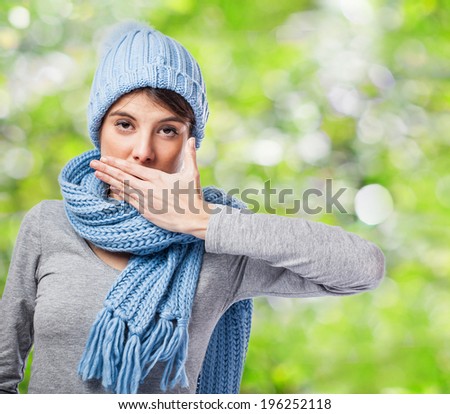portrait of a pretty young woman doing silence gesture
