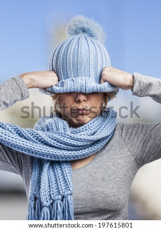 portrait of a pretty young woman covering her head with a wool cap
