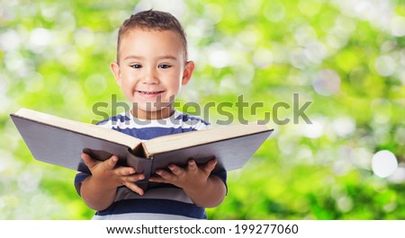 portrait of a cute kid holding a big book