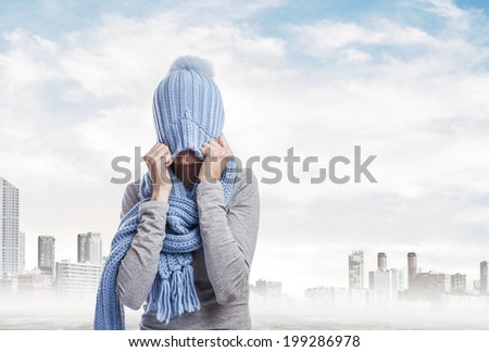 portrait of a pretty young woman covering her head with a wool cap