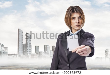 portrait of an executive young woman showing seriously her white card