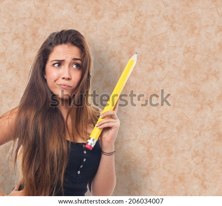 portrait of a young student holding a pencil and thinking about something