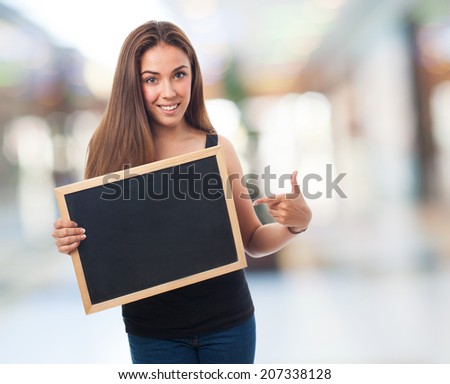 portrait of a young woman holding a chalkboard