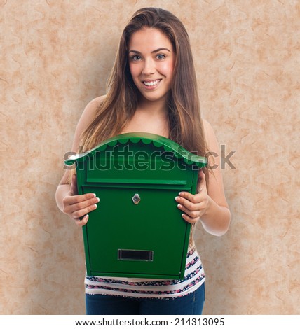 portrait of a young woman holding a green mailbox