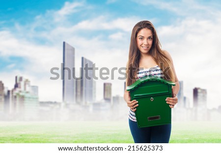 portrait of a girl holding a green mailbox