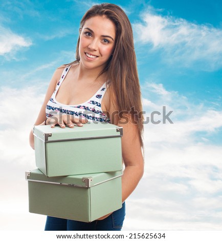 portrait of young woman holding a vintage boxes