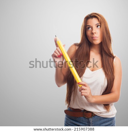 portrait of a young woman holding a yellow pencil