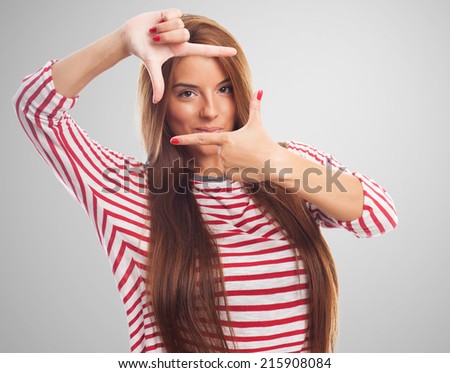 portrait of a young woman doing a frame gesture
