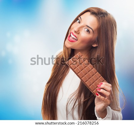 portrait of a beautiful young woman holding a chocolate tablet